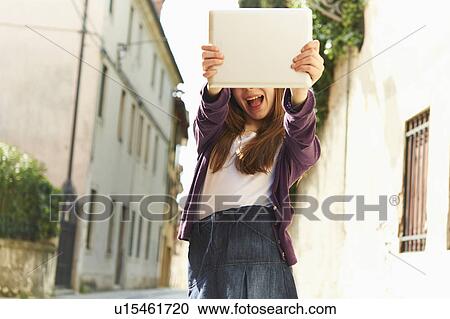 Girl photographing with digital tablet on street, Province of Venice, Italy View Large Photo Image Stock Image - Girl photographing with digital tablet on street, Province of Venice, Italy. Fotosearch