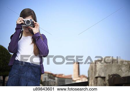 Stock Image - Girl taking photograph, Province of Venice, Italy. Fotosearch