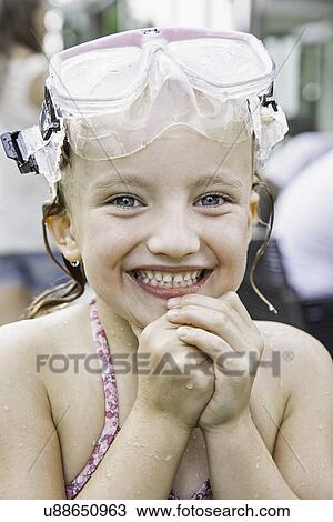 Girl with goggles on head clasping hands View Large Photo Image Stock Image - Girl with goggles on head clasping hands. Fotosearch