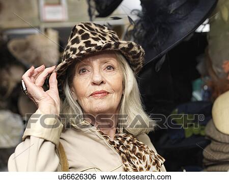 Stock Photograph - Glamorous senior woman in leopardskin hat. Fotosearch