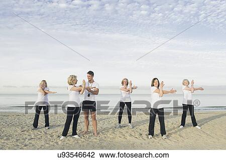 Group of mature and senior women practicing yoga on beach View Large Photo Image Stock Image - Group of mature and senior women practicing yoga on beach. Fotosearch
