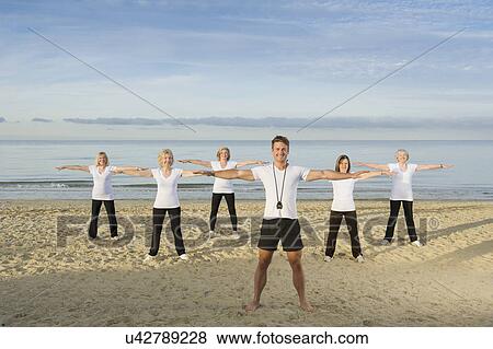 Group of mature and senior women exercising on beach View Large Photo Image Stock Photo - Group of mature and senior women exercising on beach. Fotosearch