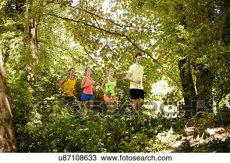 Group of runners running in woods View Large Photo Image Stock Image - Group of runners running in woods. Fotosearch