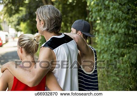 Stock Image - Group of runners watching and waiting at finish. Fotosearch