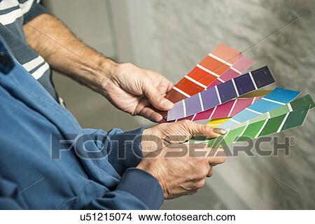 Picture - Hands of senior couple holding colour charts. Fotosearch