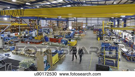 High angle view of workers in engineering factory View Large Photo Image Stock Image - High angle view of workers in engineering factory. Fotosearch