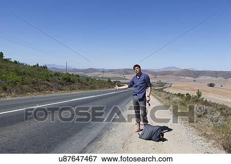 Stock Photo - Hitchhiker on side of road. Fotosearch