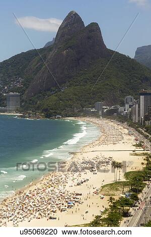 Stock Image - Holiday makers on Ipanema beach, Rio De Janeiro, Brazil. Fotosearch