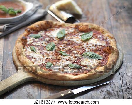 Homemade margherita pizza with mozzarella cheese and fresh basil View Large Photo Image Stock Photo - Homemade margherita pizza with mozzarella cheese and fresh basil. Fotosearch