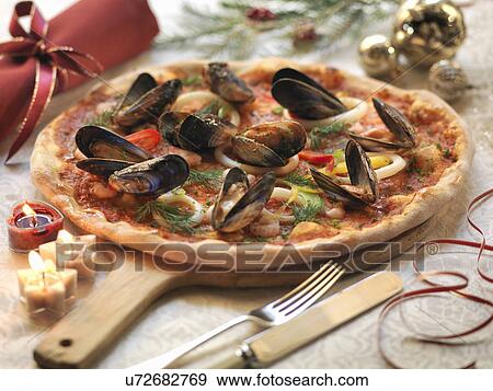 Homemade seafood pizza topped with calamari, prawns and mussels with festive decorations View Large Photo Image Stock Photo - Homemade seafood pizza topped with calamari, prawns and mussels with festive decorations. Fotosearch