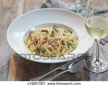 Linguini carbonara made with smoked pancetta, fresh eggs, nutmeg, cream, parmesan cheese and black pepper View Large Photo Image Stock Photo - Linguini carbonara made with smoked pancetta, fresh eggs, nutmeg, cream, parmesan cheese and black pepper. Fotosearch