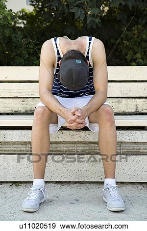 Male basketball player taking a break on park bench View Large Photo Image Stock Photo - Male basketball player taking a break on park bench. Fotosearch