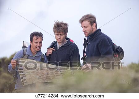 Picture - Male hikers looking at map. Fotosearch