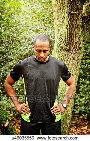 Stock Photo - Man doing breathing exercise in woods. Fotosearch