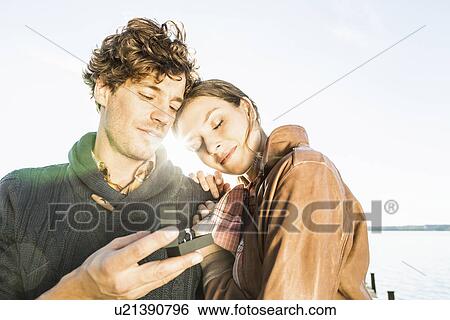Stock Photograph - Man giving woman engagement ring. Fotosearch