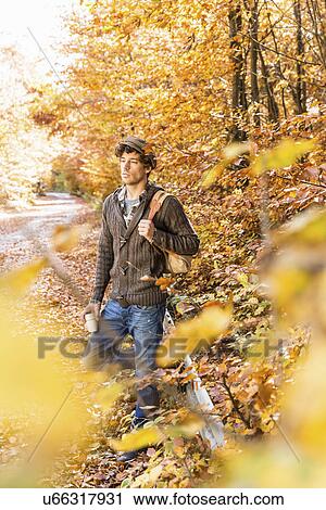 Stock Image - Man in forest with backpack. Fotosearch