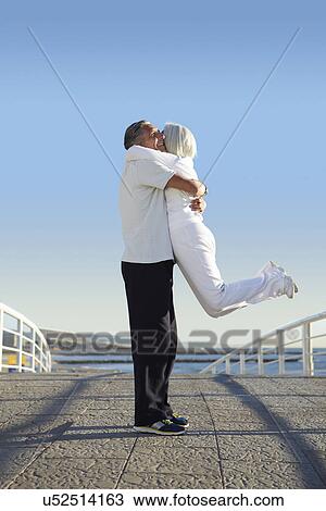 Man lifting woman up View Large Photo Image Stock Image - Man lifting woman up. Fotosearch