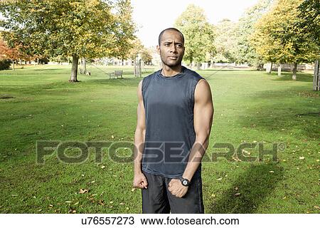 Man standing in park View Large Photo Image Stock Image - Man standing in park. Fotosearch