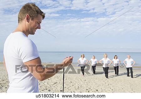 Mature and senior women and trainer having fitness class on beach View Large Photo Image Picture - Mature and senior women and trainer having fitness class on beach. Fotosearch