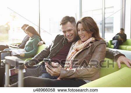 Mature couple in departure lounge View Large Photo Image Stock Photo - Mature couple in departure lounge. Fotosearch