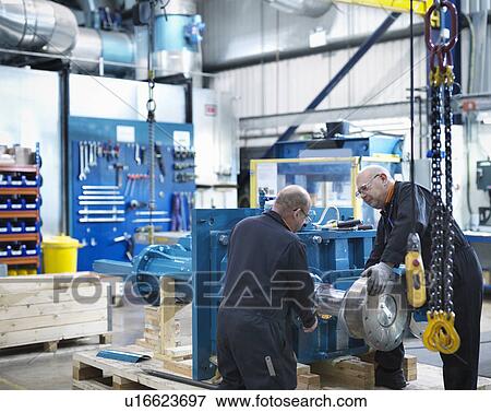 Mature engineers working in engineering factory View Large Photo Image Stock Photo - Mature engineers working in engineering factory. Fotosearch