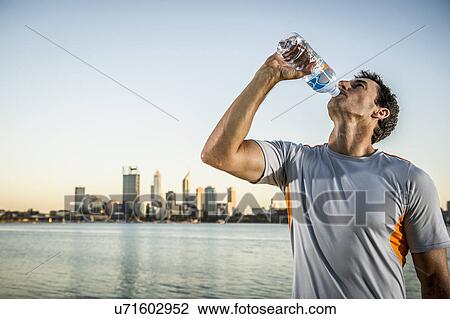 Mature male runner drinking water, Perth, Australia View Large Photo Image Stock Image - Mature male runner drinking water, Perth, Australia. Fotosearch