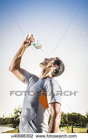 Mature male runner pouring water bottle over his face View Large Photo Image Stock Image - Mature male runner pouring water bottle over his face. Fotosearch