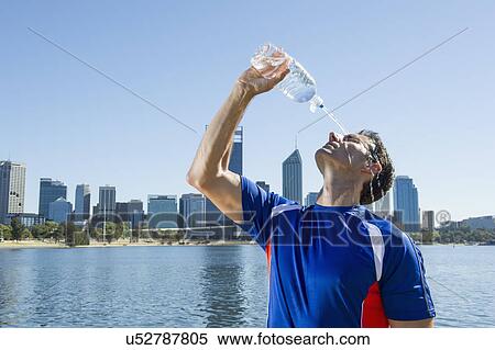 Mature male runner pouring water over his face, Perth, Australia View Large Photo Image Stock Photography - Mature male runner pouring water over his face, Perth, Australia. Fotosearch