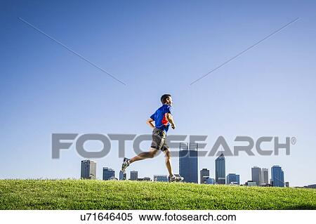 Stock Photography - Mature male running through park, Perth, Australia. Fotosearch