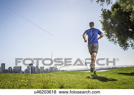 Stock Photo - Mature man running in park, Perth, Australia. Fotosearch
