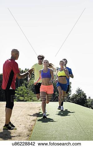 Mature man training a group of adult runners View Large Photo Image Stock Image - Mature man training a group of adult runners. Fotosearch