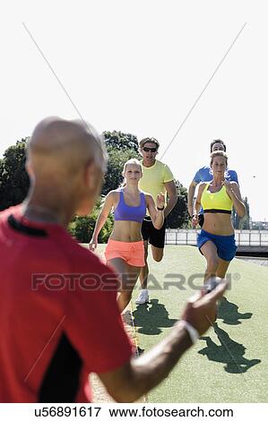 Mature man training a group of adult runners View Large Photo Image Stock Photo - Mature man training a group of adult runners. Fotosearch