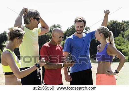 Mature trainer celebrating timing with group of adults View Large Photo Image Stock Photo - Mature trainer celebrating timing with group of adults. Fotosearch