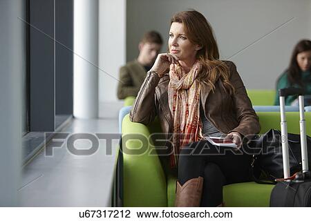 Mature woman in departure lounge View Large Photo Image Stock Image - Mature woman in departure lounge. Fotosearch