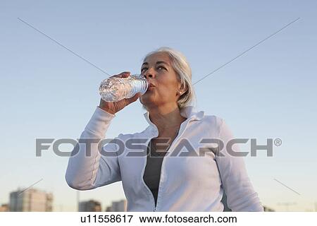 Stock Photo - Mature woman on walking exercise. Fotosearch