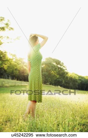 Mid adult woman daydreaming in summer meadow View Large Photo Image Stock Photography - Mid adult woman daydreaming in summer meadow. Fotosearch