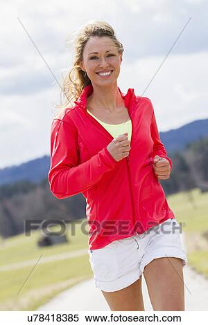 Mid adult woman jogging View Large Photo Image Stock Photography - Mid adult woman jogging. Fotosearch