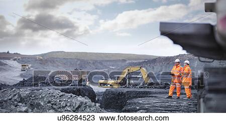 Miners in discussion in surface coal mine View Large Photo Image Stock Image - Miners in discussion in surface coal mine. Fotosearch