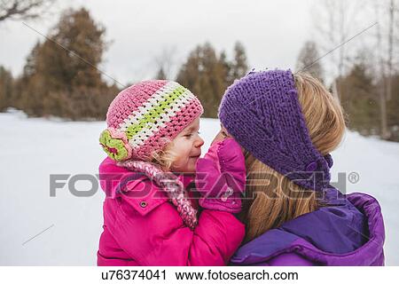 Mother and daughter wearing winter clothing, face to face in snow View Large Photo Image Stock Image - Mother and daughter wearing winter clothing, face to face in snow. Fotosearch