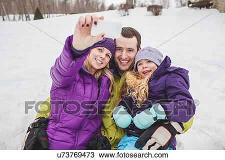 Mother and Father with daughter taking family portrait with mobile phone View Large Photo Image Stock Image - Mother and Father with daughter taking family portrait with mobile phone. Fotosearch