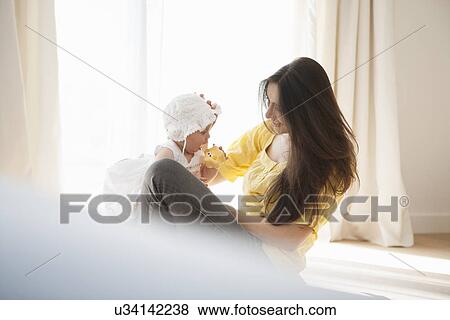 Mother playing with baby View Large Photo Image Stock Photo - Mother playing with baby. Fotosearch