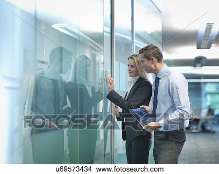Office workers adjusting heating thermostat in modern workplace View Large Photo Image Picture - Office workers adjusting heating thermostat in modern workplace. Fotosearch