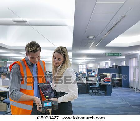 Office workers looking at digital tablet and thermal infrared images in office View Large Photo Image Stock Photo - Office workers looking at digital tablet and thermal infrared images in office. Fotosearch