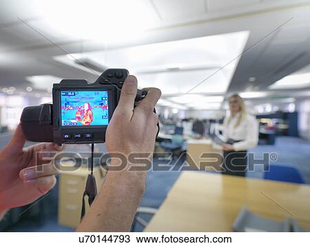 Office workers taking thermal infrared images in office to check heat efficiency View Large Photo Image Stock Image - Office workers taking thermal infrared images in office to check heat efficiency. Fotosearch