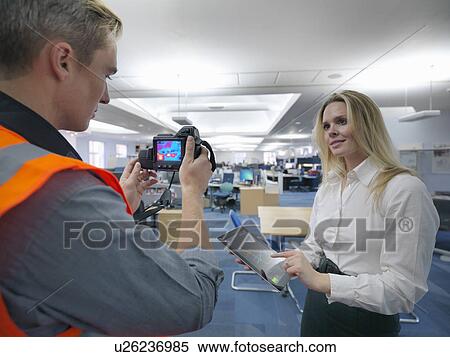 Stock Photography - Office workers taking thermal infrared images in office to check heat efficiency. Fotosearch