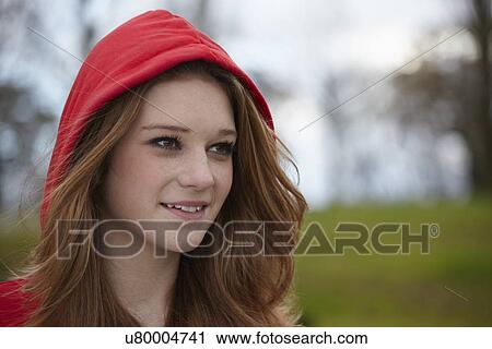 Outdoor portrait of a teenage girl in red hood View Large Photo Image Stock Image - Outdoor portrait of a teenage girl in red hood. Fotosearch