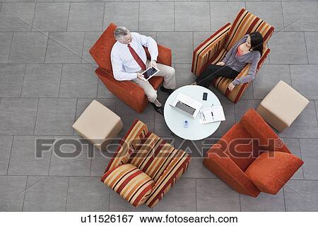 Overhead view of interview in office atrium View Large Photo Image Stock Photo - Overhead view of interview in office atrium. Fotosearch