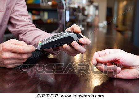 Stock Photo - Paying bill by credit card. Fotosearch