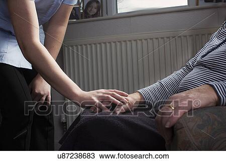 Personal care assistant comforting senior woman View Large Photo Image Stock Image - Personal care assistant comforting senior woman. Fotosearch