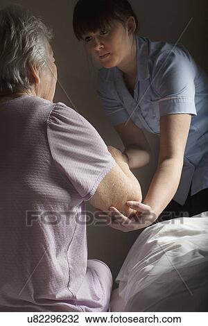 Personal care assistant helping senior woman to get up View Large Photo Image Stock Image - Personal care assistant helping senior woman to get up. Fotosearch